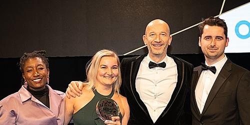 Christophe Vergult at Human8 and Marieke Boers of Philips collect the award on stage at the MRS Awards 2023.